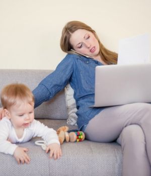 woman on call with her child next to her